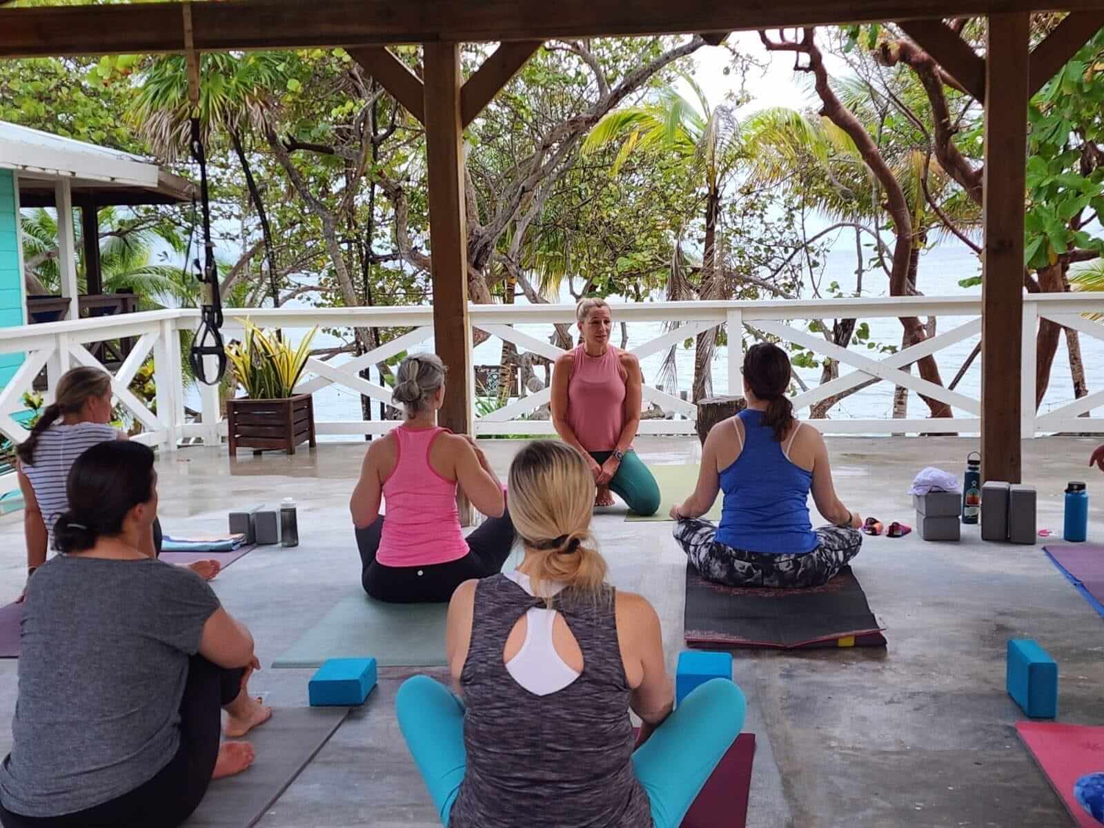 A yoga and meditation session on the deck above the water
