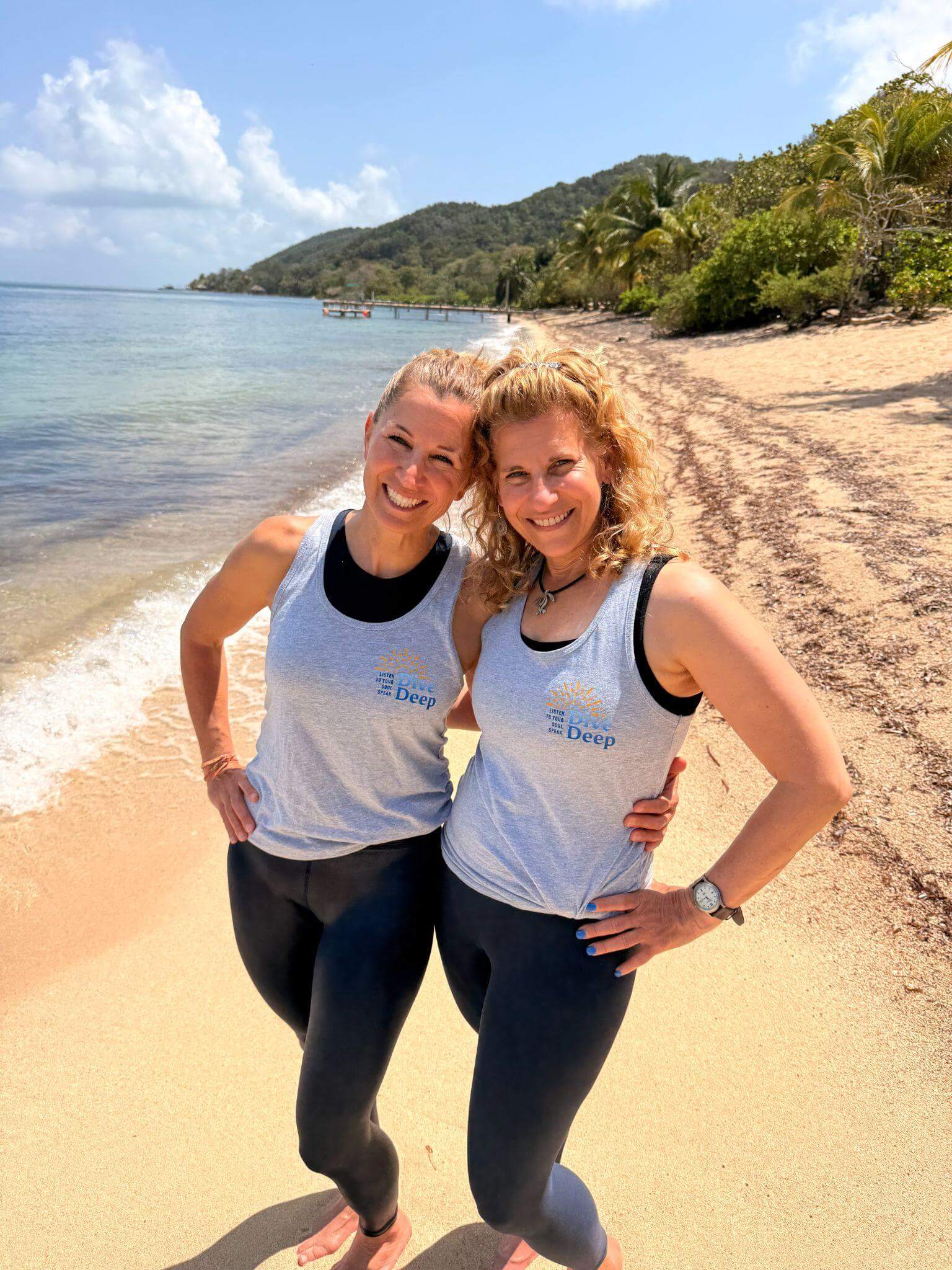 Adina Tovell and Lisa Oplinger on the beach at Camp Bay in Dive Deep tank tops