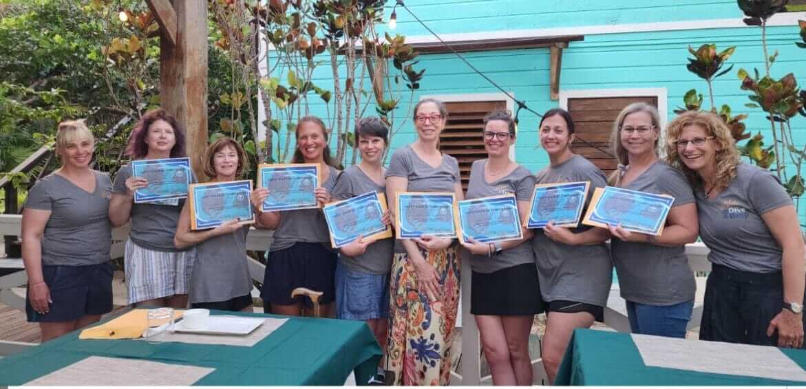 The group holding their Discover Scuba certificates